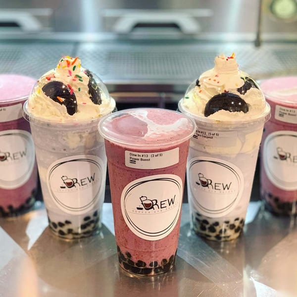 Five Brew Coffee and Bakery boba drinks, some topped with whipped cream, cookies, and sprinkles.
