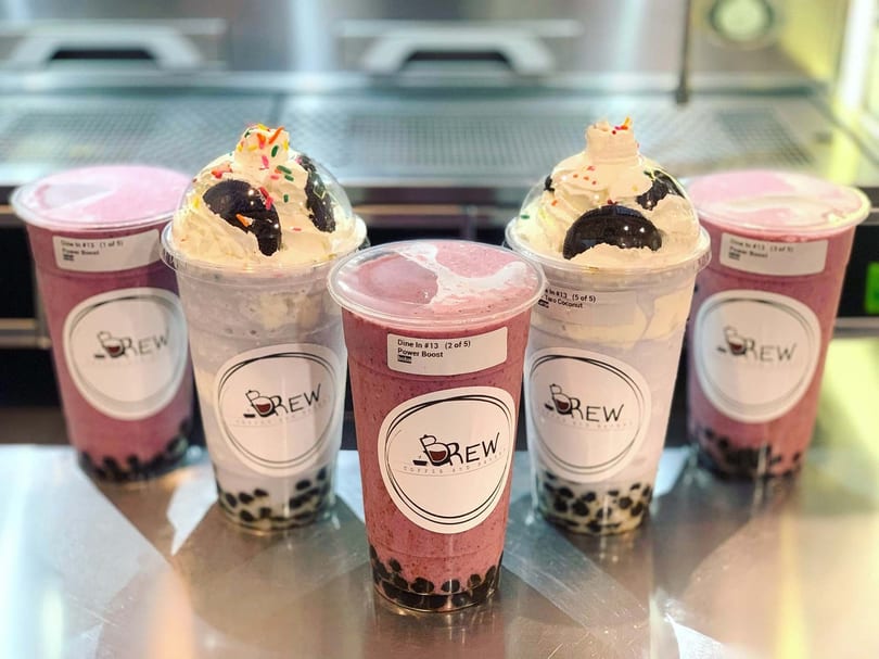 Five Brew Coffee and Bakery boba drinks, some topped with whipped cream, cookies, and sprinkles.